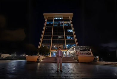 Man standing in front of El Paso City Hall at night.