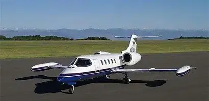 White and blue private jet on airfield