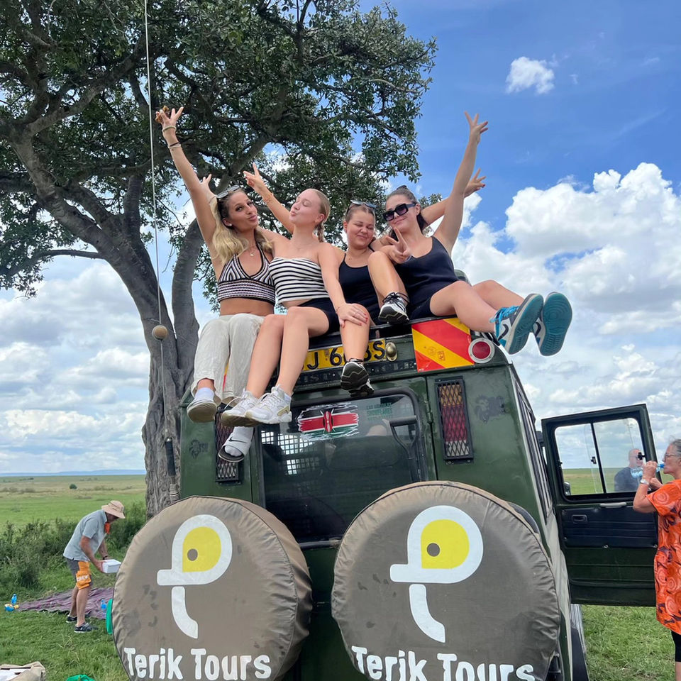 Four women smiling on a Terik Tours safari vehicle