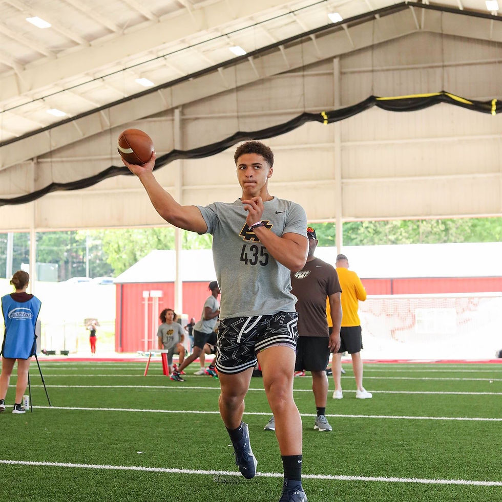 Eye-level view of a high school quarterback scanning the field before a snap