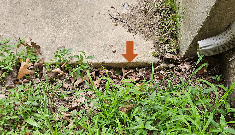 Detached gutter erosion at the foundation during a home inspection