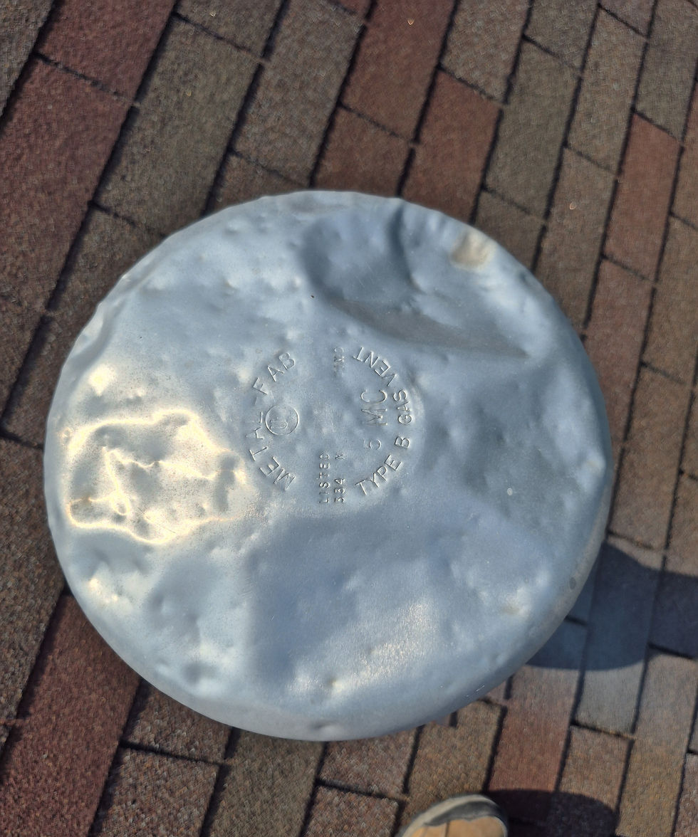 Photo: hail dents on a metal gas vent flue cap