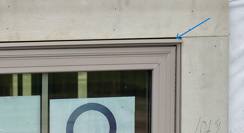 Field photo from a pre-drywall inspection of head flashing over a double window unit.