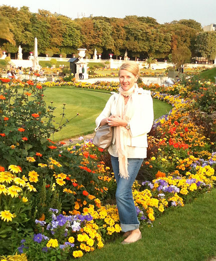 Kimberly Headen designer of The Blossom Boutique A Redesign Company in NYC surrounded by beautiful blossoms and colorful flowers