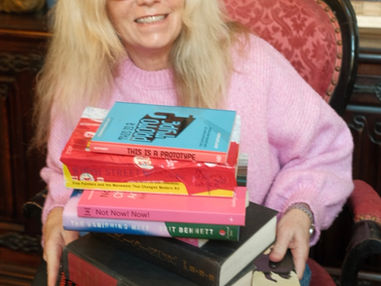 Lisa Woolery holding books about widowhood and grief healing after losing a spouse