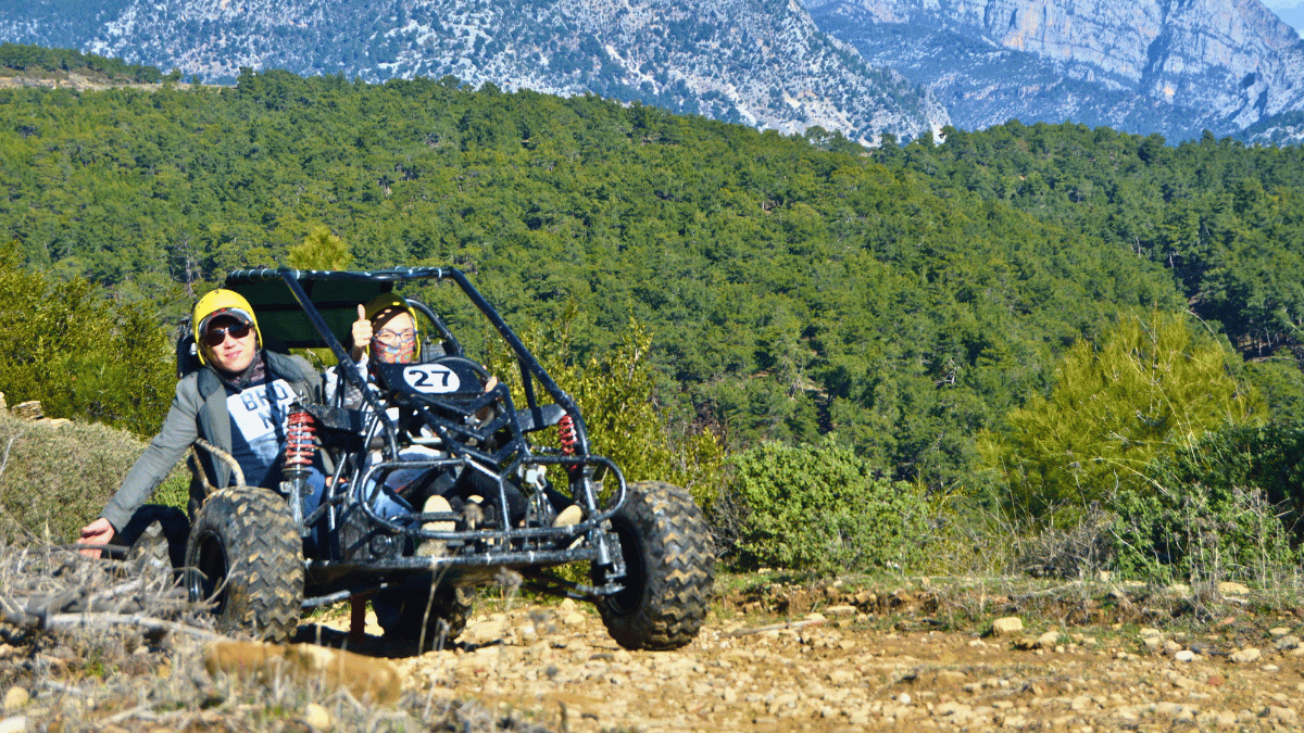 Foreign tourists riding buggy cars through muddy forest trails near Alanya, during an off-road adventure tour with Turcome.