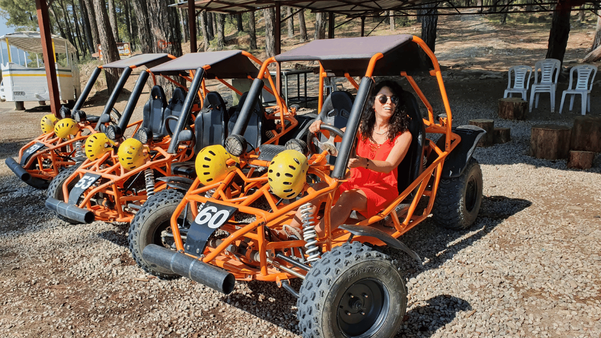 Foreign tourists riding buggy cars through muddy forest trails near Alanya, during an off-road adventure tour with Turcome.