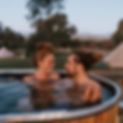 Couple in a wood fired hot tub at Mansfield Glamping adults only glamping retreat