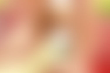 Woman in yellow tank top applying Malina Lemon deodorant near a running track. Bright setting, relaxed mood.