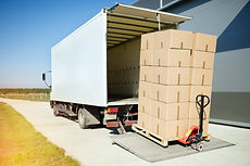 Truck transporting goods packed in boxes from warehouse.jpg