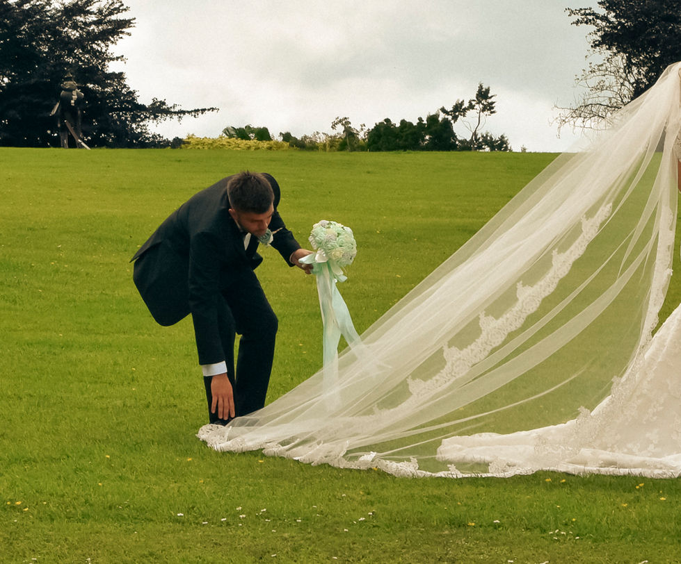 husband fixing wifes veil for photo shoot