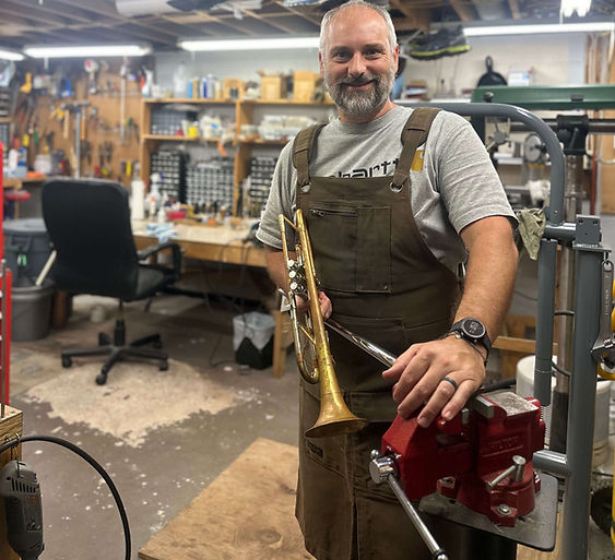 jeremy-holding-repaired-trumpet-smiling.jpg