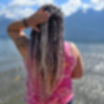 woman with custom dreadlock extensions on a beach