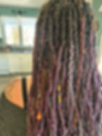 Eye-level view of a stylist preparing custom dreadlock extensions