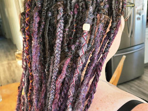 Custom dreadlock extensions in purples, black, grey and wine made by The Bold Artisan Boutique