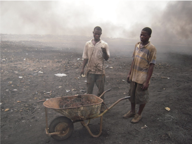 E-waste workers in Agbogbloshie, Ghana, completing a burn for copper recovery