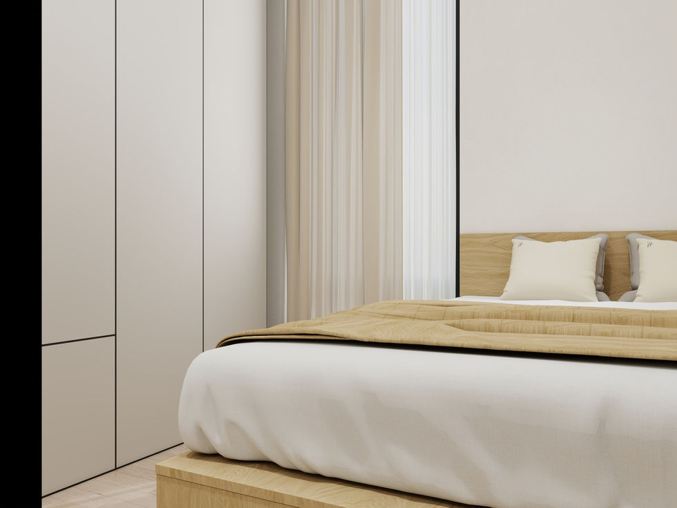 “Minimal bedroom with low wood platform bed, white bedding, camel quilt and tall wardrobes beside beige curtains.”