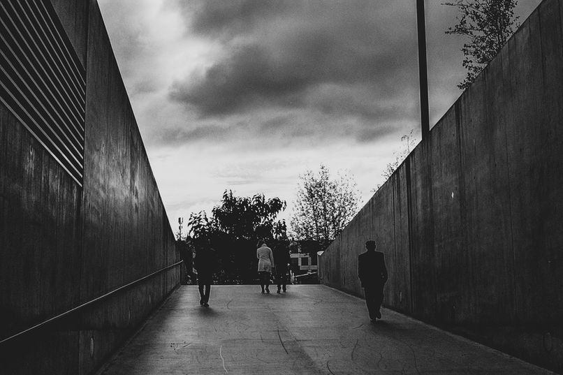 B&W silhouettes of travellers in urban tunnel Studio Barco Zurich