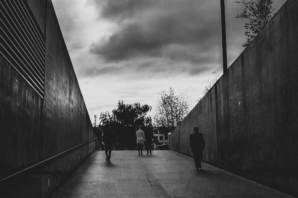 B&W silhouettes of travellers in urban tunnel Studio Barco Zurich