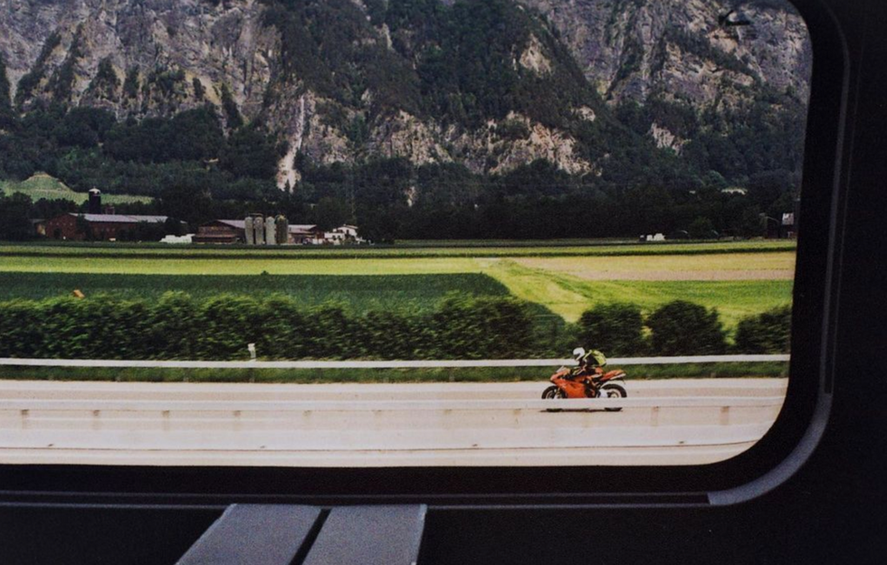 Cinematic train window view motorcycle and mountains Studio Barco