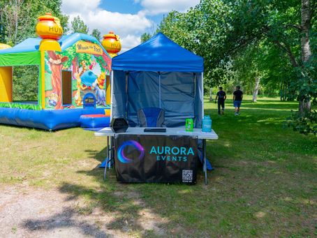 Aurora Events setup with a Winnie the Pooh inflatable and branded event tent outdoors
