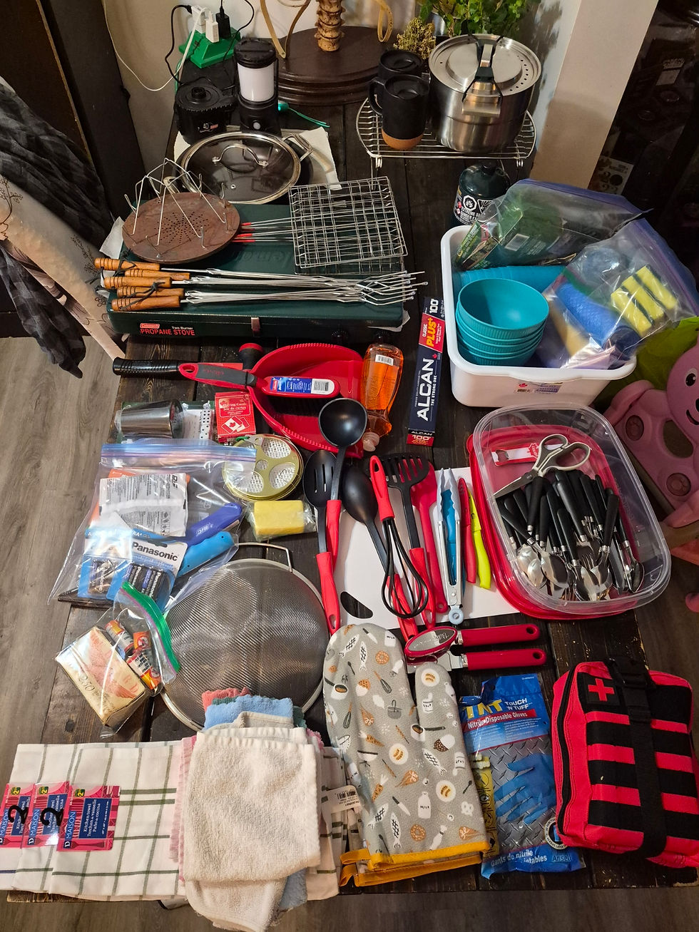 Camping gear and cooking equipment prepared for a first camping trip