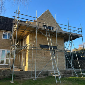 Cotswold stone extension covered in scaffolding