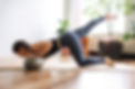 Yoga Sculpt teacher demonstrating pushup with a pilates ball