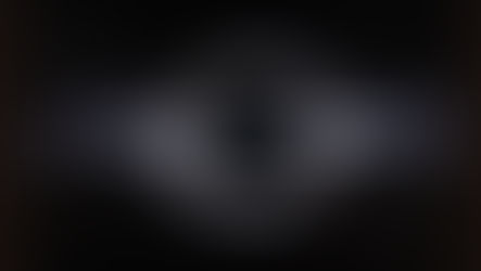 Illustration of a black hole with a glowing circular ring marking the event horizon, set against a star-filled background
