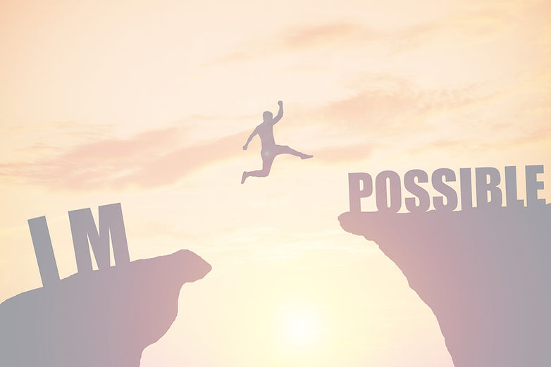 happy businessman jumping between two rocks with words_ IM POSSIBLE_edited.jpg