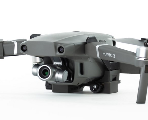 Gray drone with the text MAVIC 2 on its side, positioned against a white background. The drone features a camera and propellers. Acessories are from Drone Sky Hook