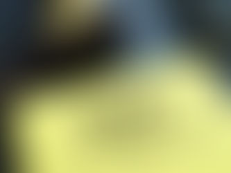 Yellow book titled "RERA: Real Estate (Regulation and Development) Act" on desk. Wooden gavel and glasses nearby. Professional setting.