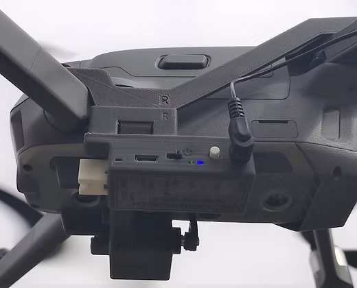Back side view of the DJI Mavic 2 drone with drone sky hook payload release and drop mechansim attached to it