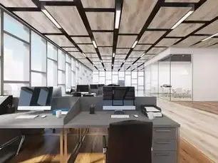 Modern office with empty desks, ergonomic chairs, and gray dividers. Bright overhead lights, colorful ceiling accents, and large windows.