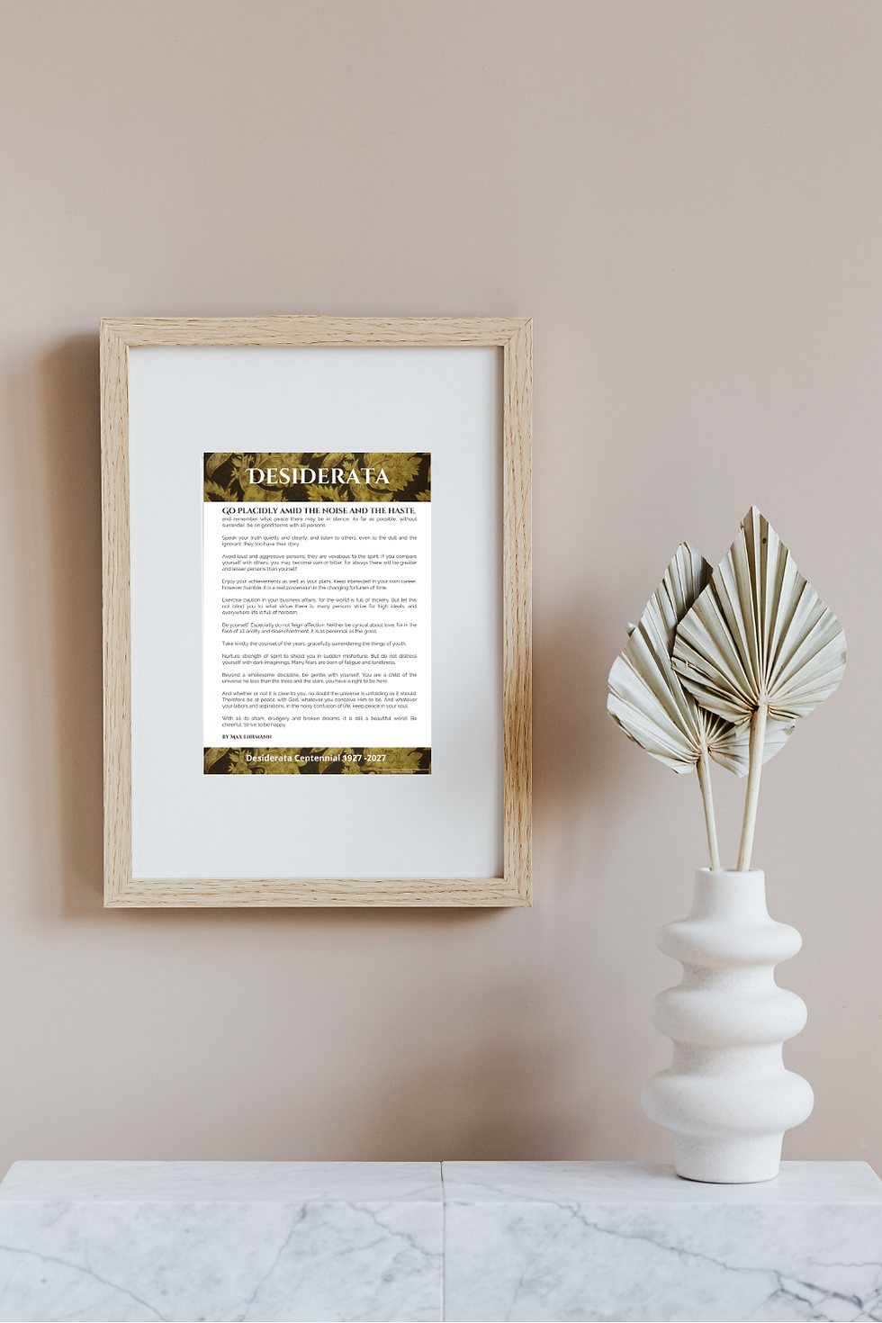 Free Vintage style Desiderata Poster printed approximately A4 and framed on a wall with a mantle and vase in front.