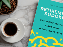 Retirement Sudoku Puzzle Book alongside a coffee and pen