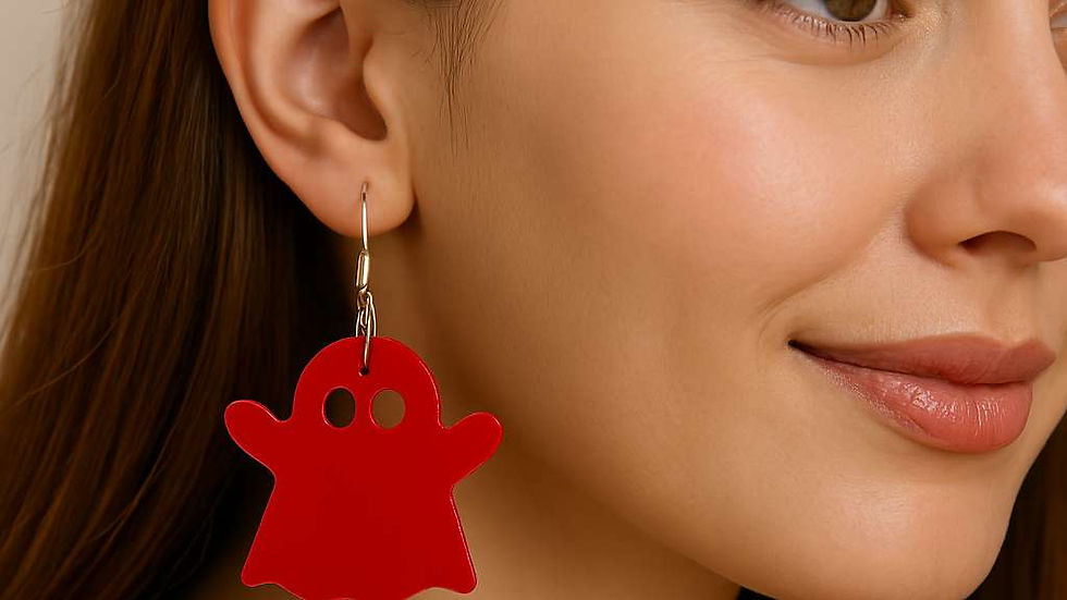 Close-up view of acrylic ghost dangle earrings on a decorative background
