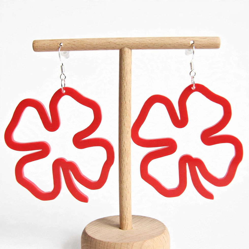 Thumbnail: Woman wearing Sylvarra Clover lucky botanical drop earrings for boho festival fashion