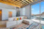 Living area with sectional sofa and floor-to-ceiling windows