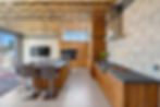 Kitchen island and seating with the living area beyond