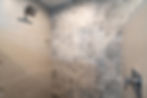 Walk-in shower with rain showerhead and large gray tile