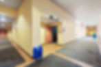 Long corridor with auditorium doors and tile border
