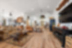 Spacious great room with kitchen, living area, vaulted ceiling, recessed lighting, and large windows