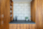 Built-in bamboo shelving and counter against a block wall
