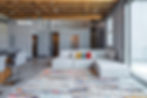 Great room with sectional sofa, rug and open loft above