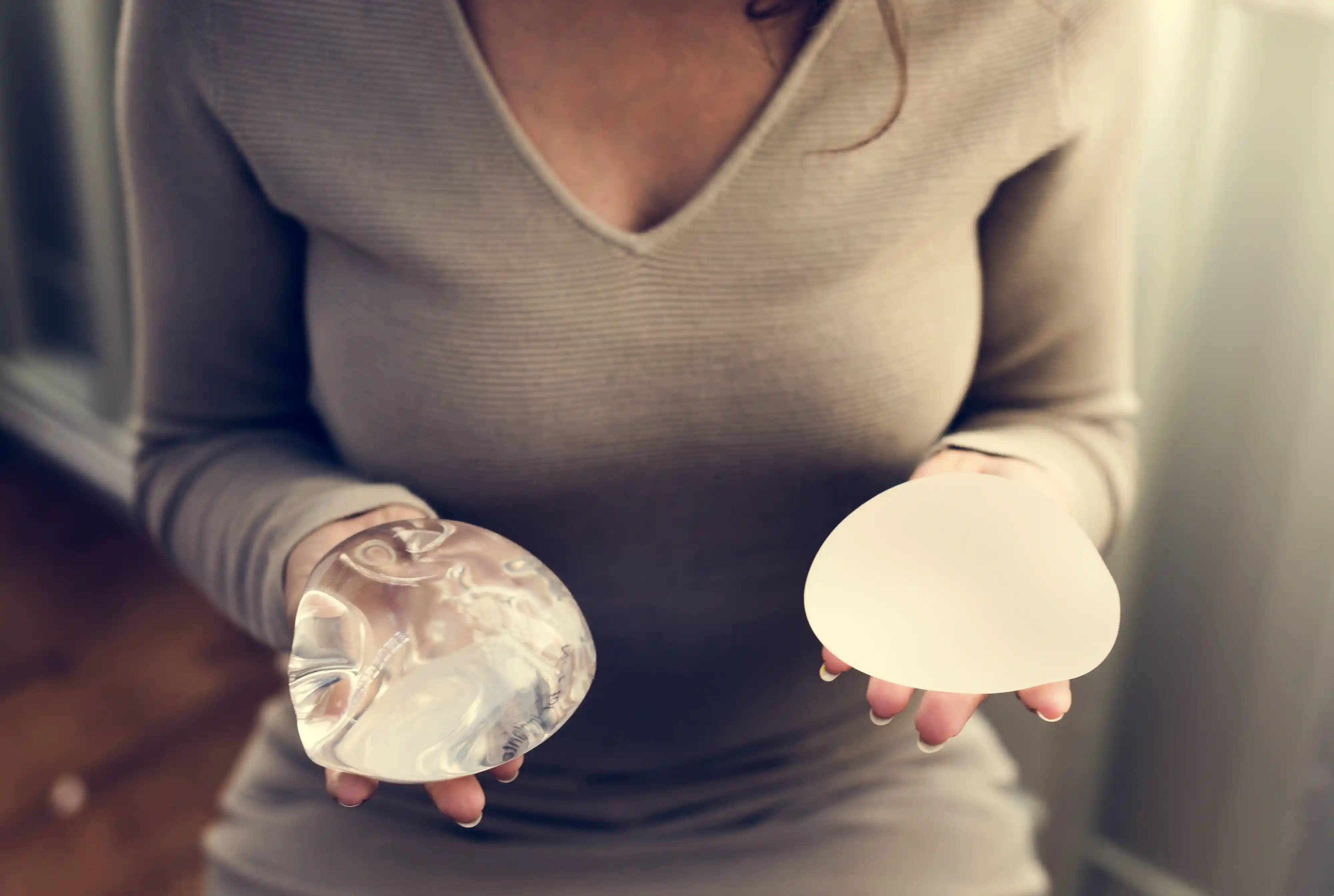 woman-holding-silicon-bags-for-breast-implant-2022-12-16-01-06-13-utc.webp