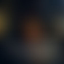 Dimly lit alley with a lone figure walking. Warm streetlights illuminate buildings. Text in the foreground. Mood is serene and contemplative.