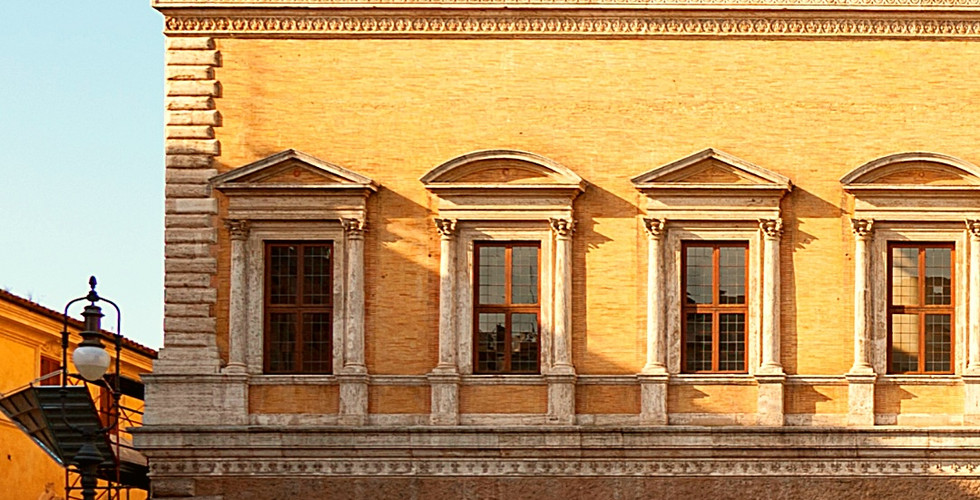 Palazzo Farnese, Rome, with light brown facade and arched windows against a clear blue sky. Text at bottom shows latitude and longitude.