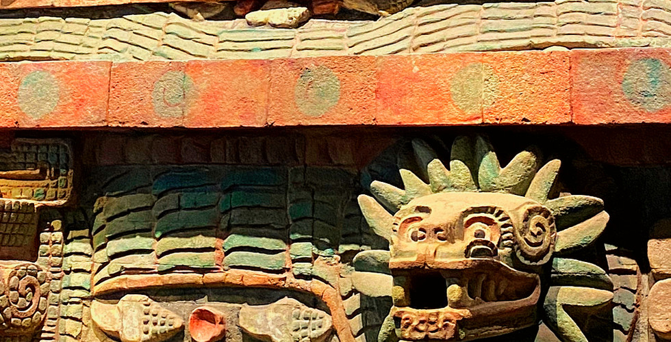 Colorful Tenochtitlan reconstruction at Museo Nacional de Antropología, Mexico, featuring detailed stone carvings of mythical creatures.