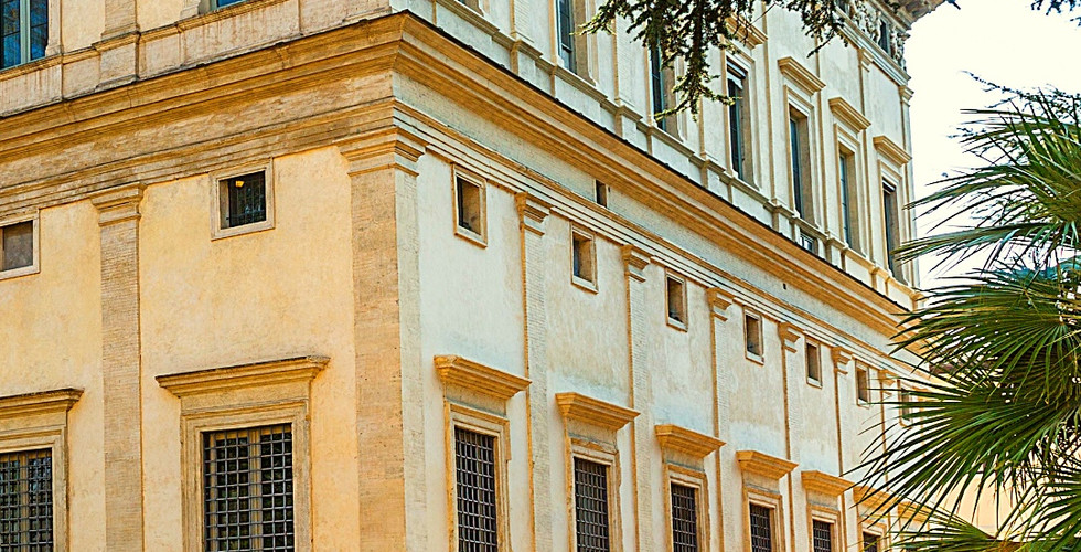 Exterior of Villa Farnesina, Rome, in sunlight. Cream walls, ornate roof, and greenery in foreground. Text: Villa Farnesina, Rome, Italy.